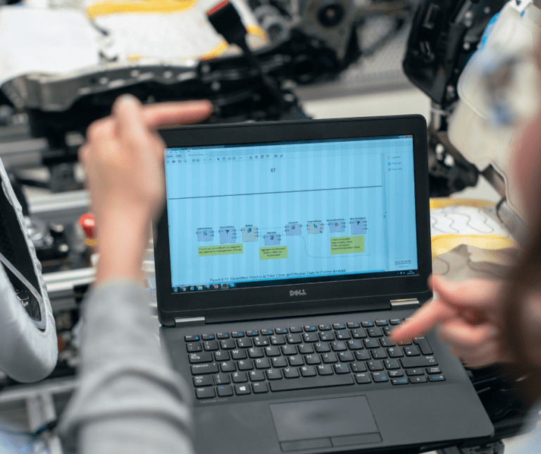 Person on DELL laptop conducting an eddy current test.