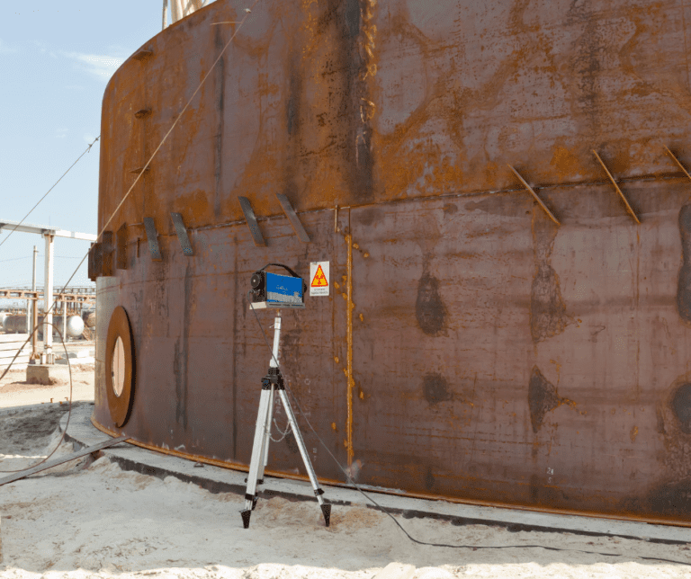 A large silo with a welding inspection being carried out to ensure safety and quality.