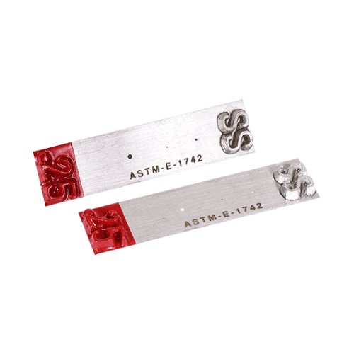 ASTM E1742 Penetrameter on a white background so you can see the image quality indicator.